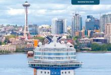 Cruise ship with Space Needle and Seattle skyline.