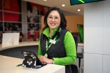 A smiling pathfinder with an iPad for language assistance 