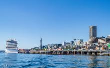 View from the water of Bell Harbor Marina, with a cruise ship docked at Pier 66, and the Space Needle in the background