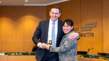 Former Commission President Toshiko Hasegawa passes the gavel to Ryan Calkins, Commission President for 2026