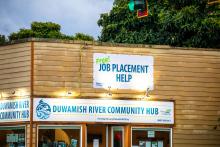 Sign on Duwamish River Community Hub that reads "Free Job Placement Help."