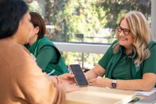 A customer in the terminal talking to a happy customer service representative. 