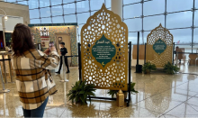 Image of customer taking a photo of Eid Al-Fitr displays in the central terminal