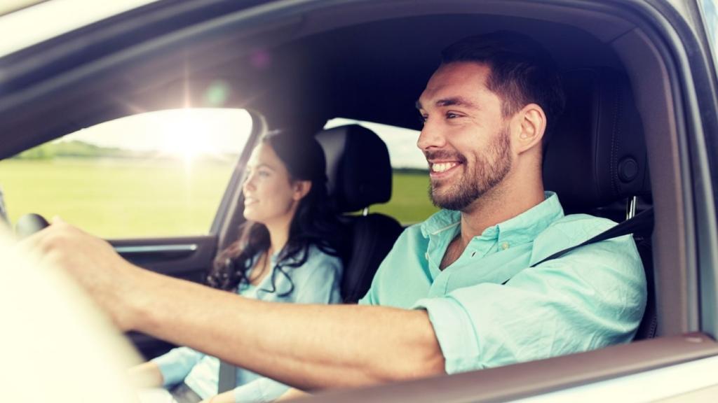 Young couple driving in a car.