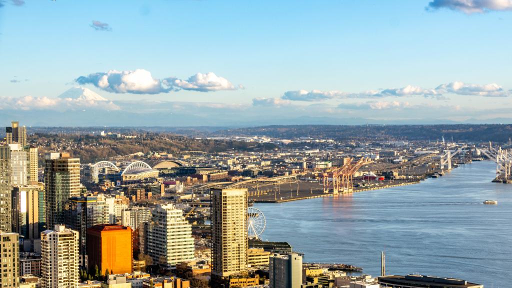 Seattle downtown skyline with partly cloudy sky and a view of the bay.